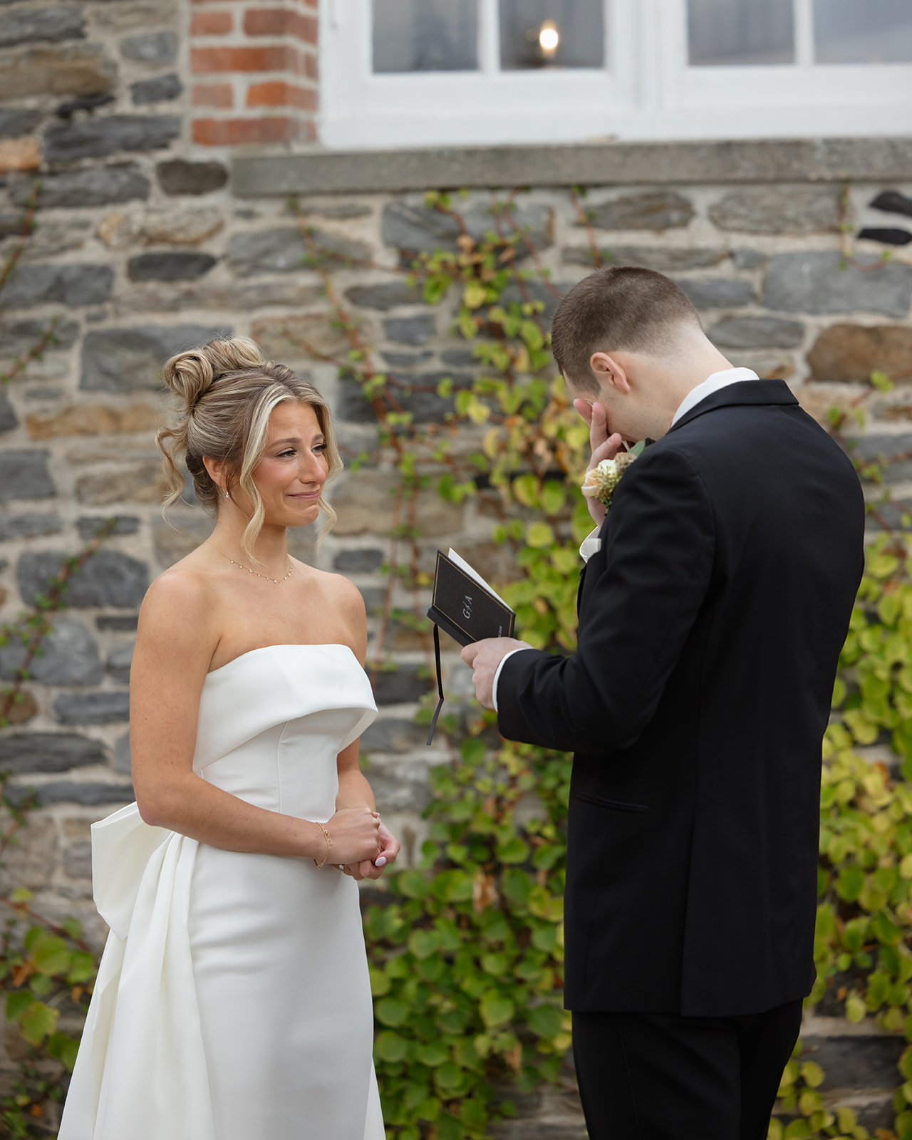 Groom reading private vows while the bride listens during an intimate ceremony at one of the elegant Wedding Venues in Rhode Island.
