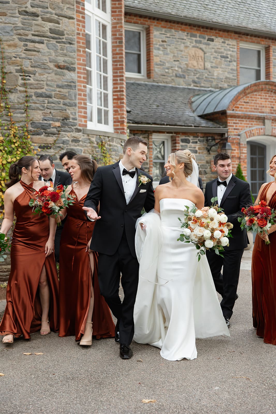 Wedding party walking together outside the historic manor during a Shepherd’s Run wedding in Rhode Island.