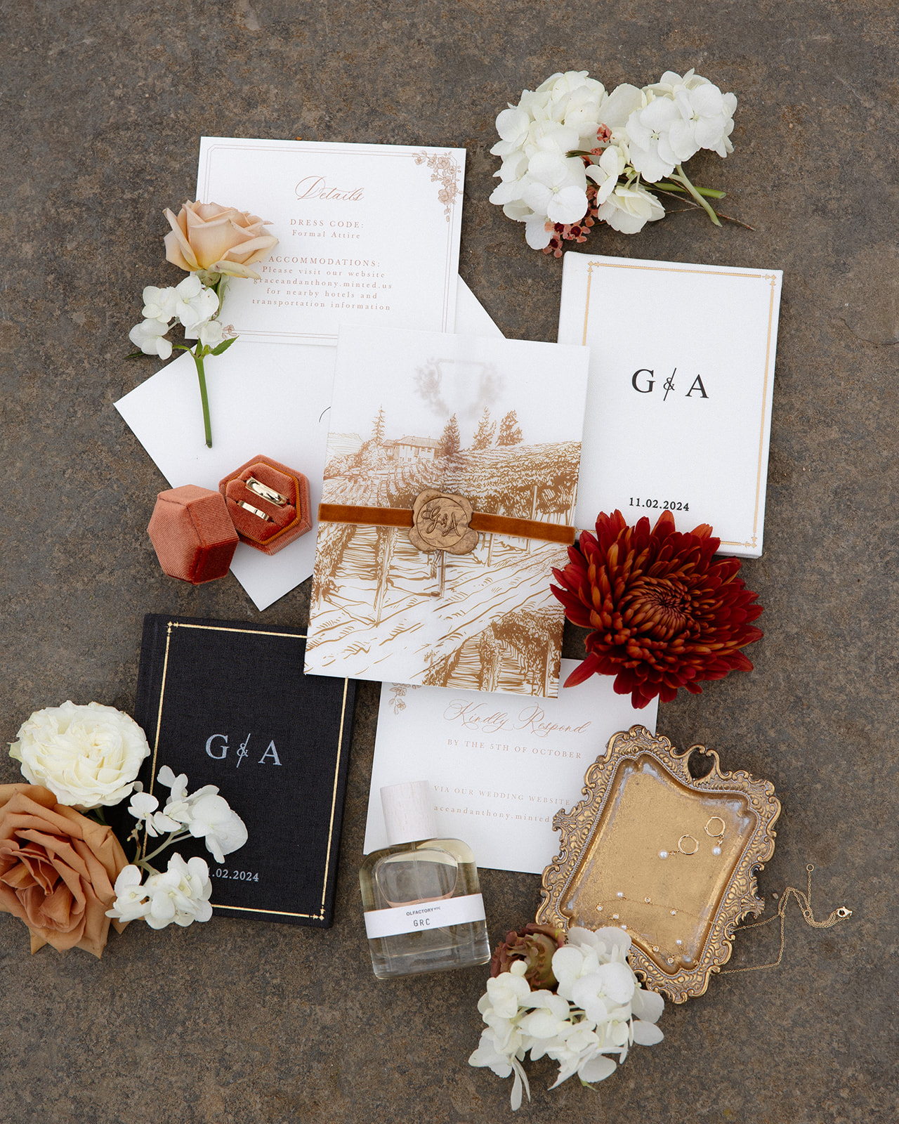 Romantic wedding invitation suite with florals, heirloom ring box, and perfume styled for a vineyard wedding at one of the most refined wedding venues in Rhode Island.