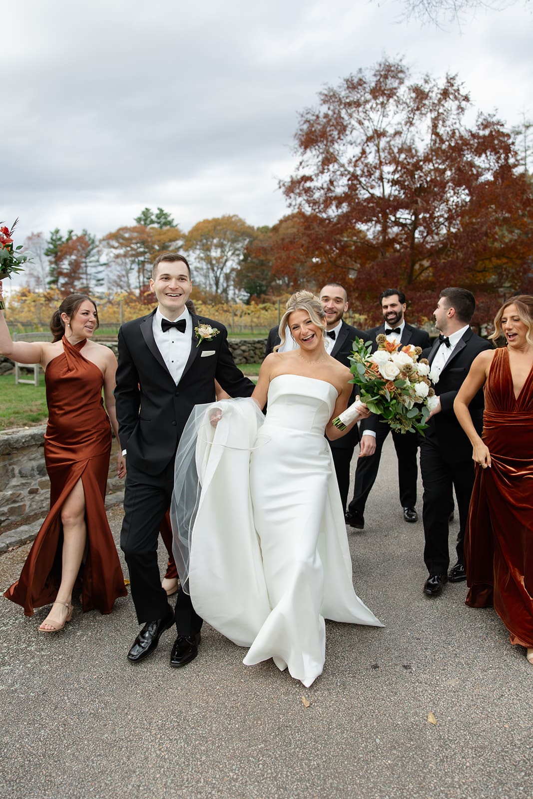 Newlyweds celebrating with bridesmaids and groomsmen at a historic vineyard wedding venue in Rhode Island.