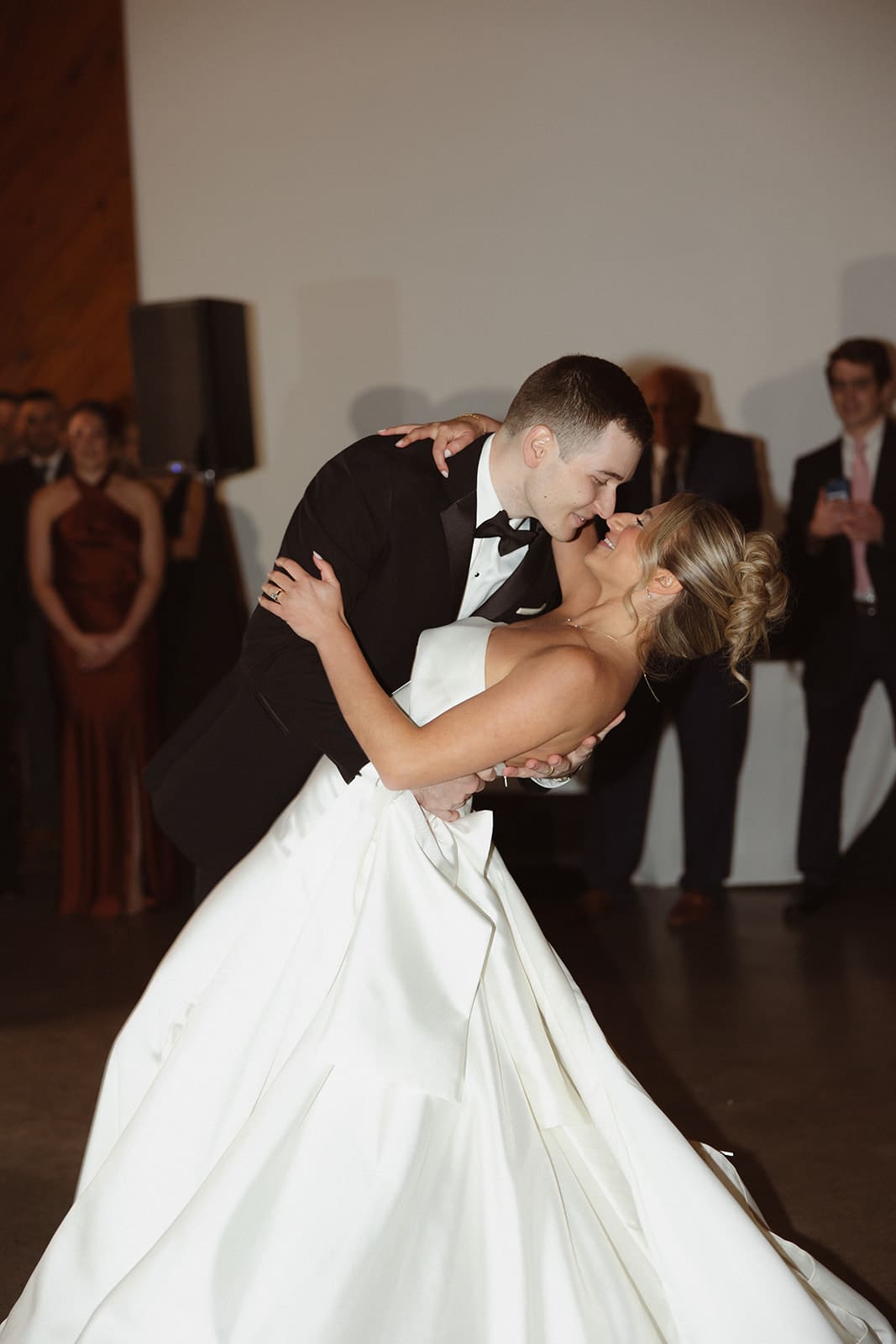 Bride and groom sharing a dramatic dip kiss on the dance floor at an elegant Rhode Island estate wedding.