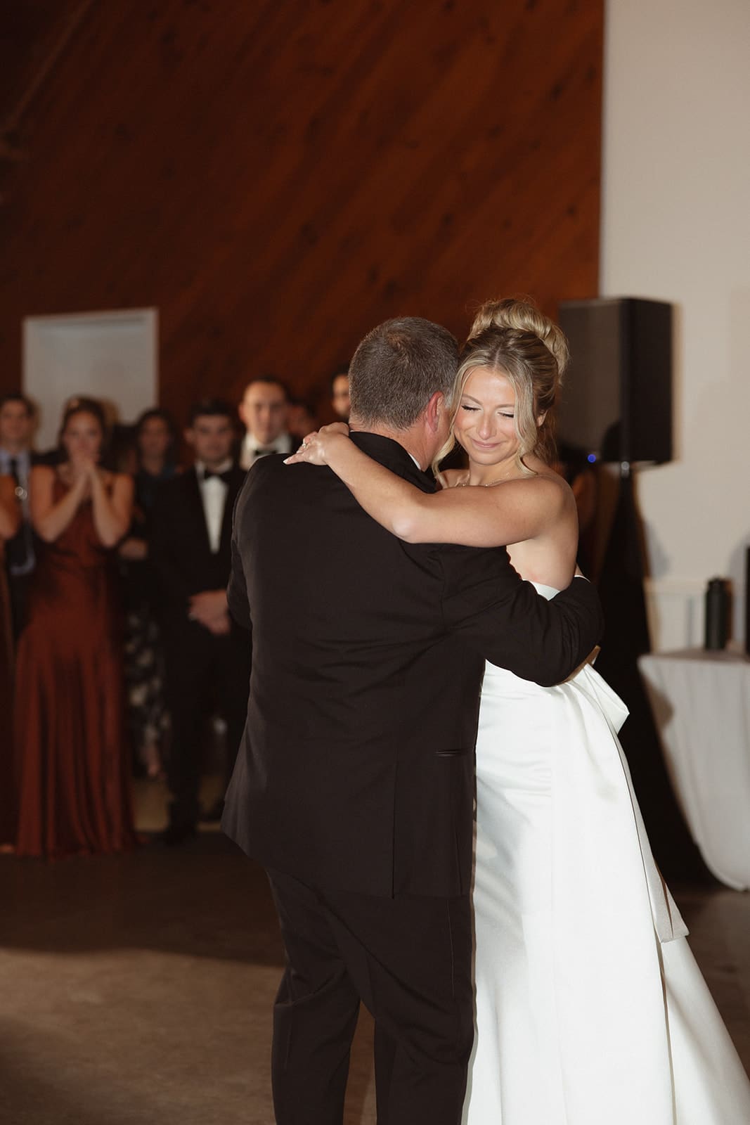 Bride sharing an emotional father-daughter dance beneath warm reception lighting at one of the most timeless wedding venues in Rhode Island.