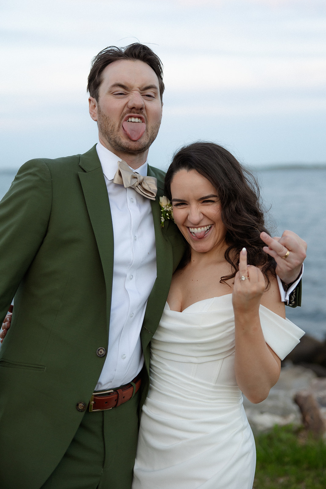 The couple laughs and leans into each other, sharing a playful moment during a colorful wedding portrait session.
