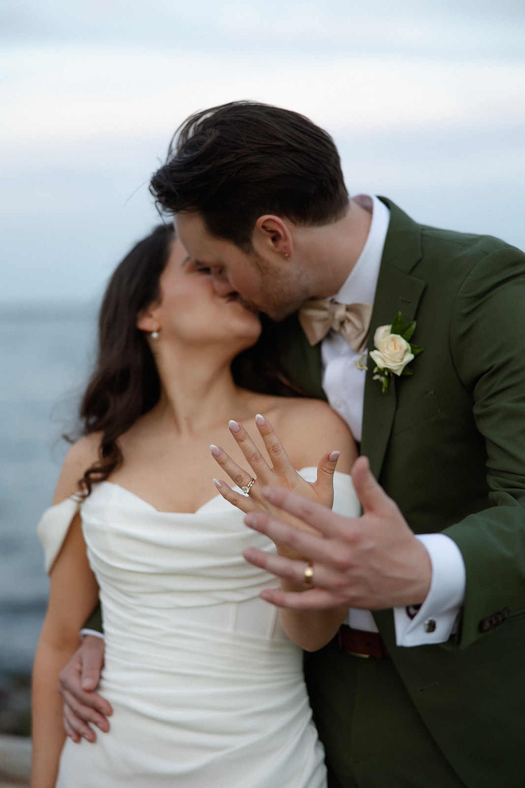 A close embrace as the couple shows their rings, marking a joyful moment during a colorful wedding day.
