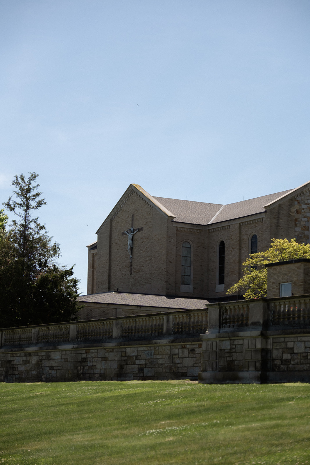 A side view of the church exterior set against a clear sky, capturing the setting of a colorful wedding ceremony.
