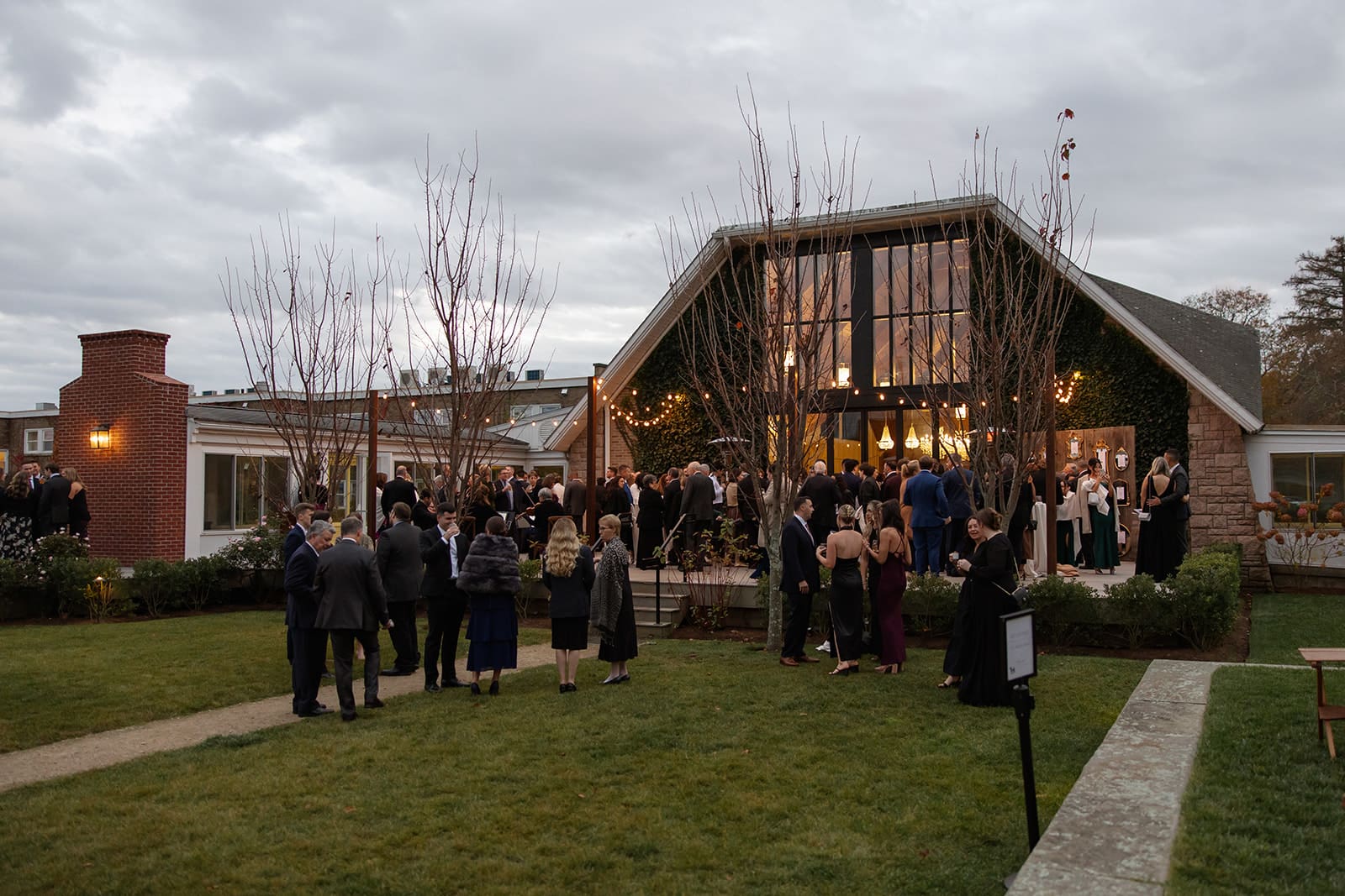 Evening cocktail hour outside a modern barn reception space at one of the elegant Wedding Venues in Rhode Island.
