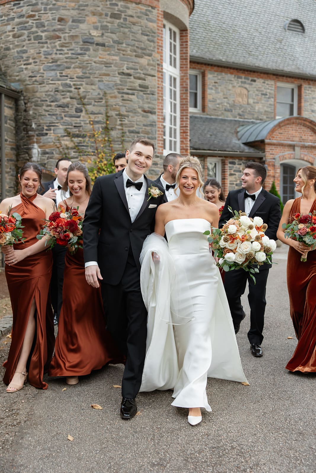 a bride and groom walking with their wedding party behind them at shepherd's run, a beautiful wedding venue in rhode island