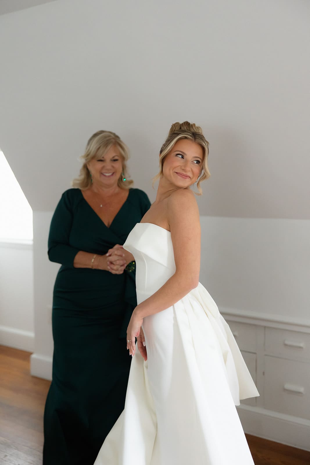 Bride smiling during a quiet moment with her mother while getting ready at one of the romantic Wedding Venues in Rhode Island.
