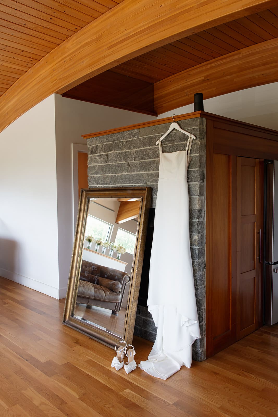 Minimal bridal details with wedding dress and heels displayed in bridal suite at a Connecticut wedding venue
