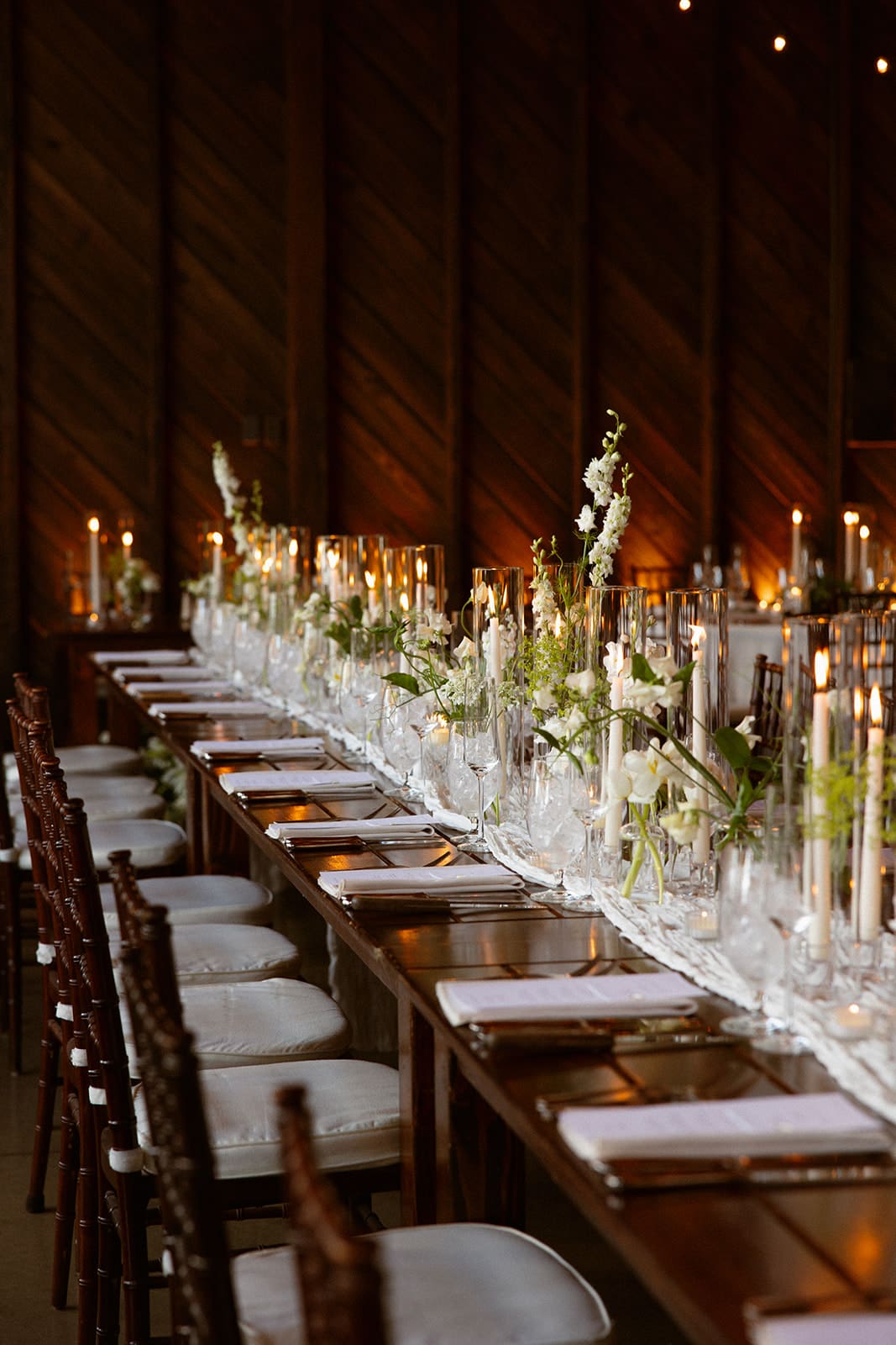 Elegant reception head table with tall glass candle centerpieces at a Connecticut wedding venue
