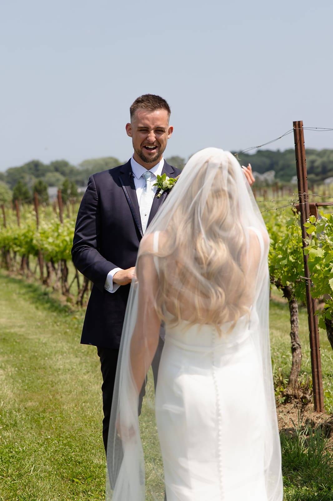 Groom reacting during emotional first look in vineyard at a Connecticut wedding venue
