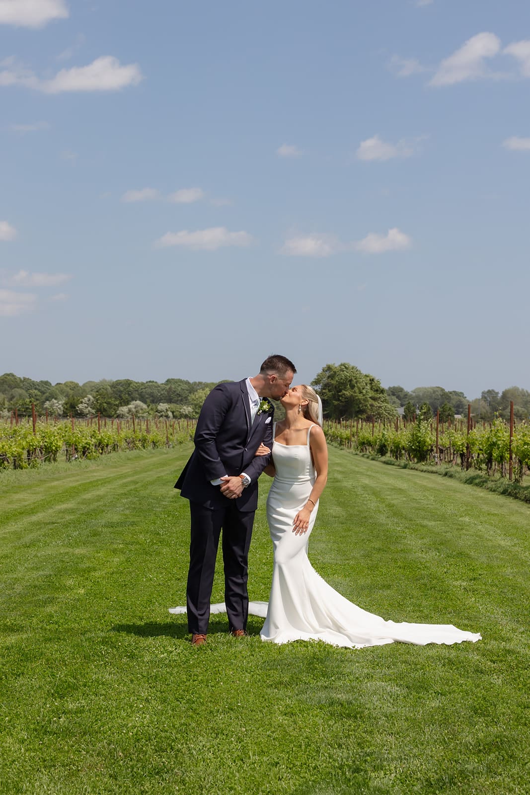 Bride and groom sharing a kiss in vineyard ceremony space at a Connecticut wedding venue
