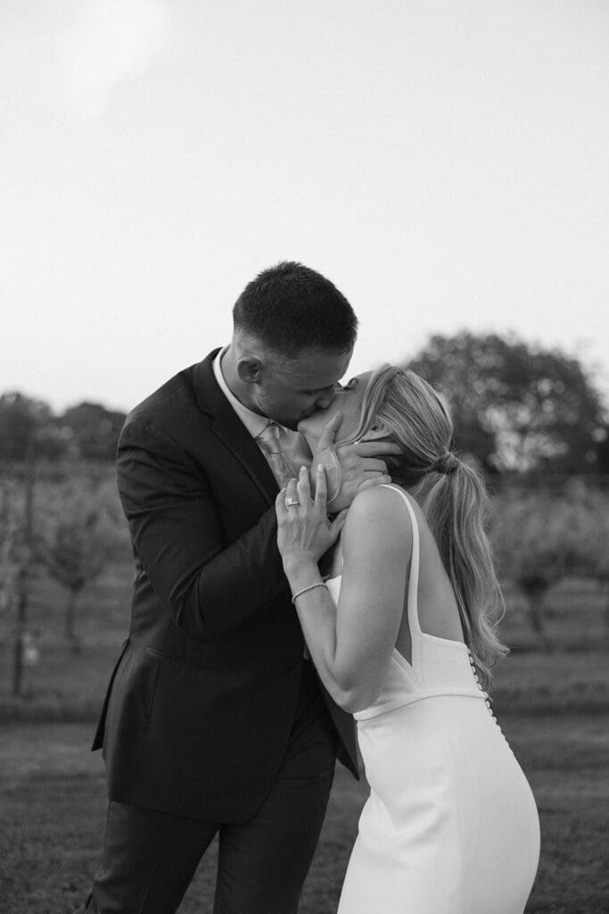 Bride and groom share a quiet kiss during sunset portraits at a Connecticut wedding venue
