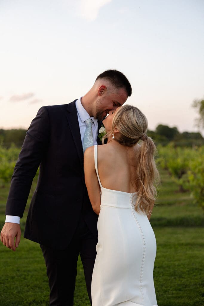 Bride and groom sharing a quiet golden hour moment in the vineyard
